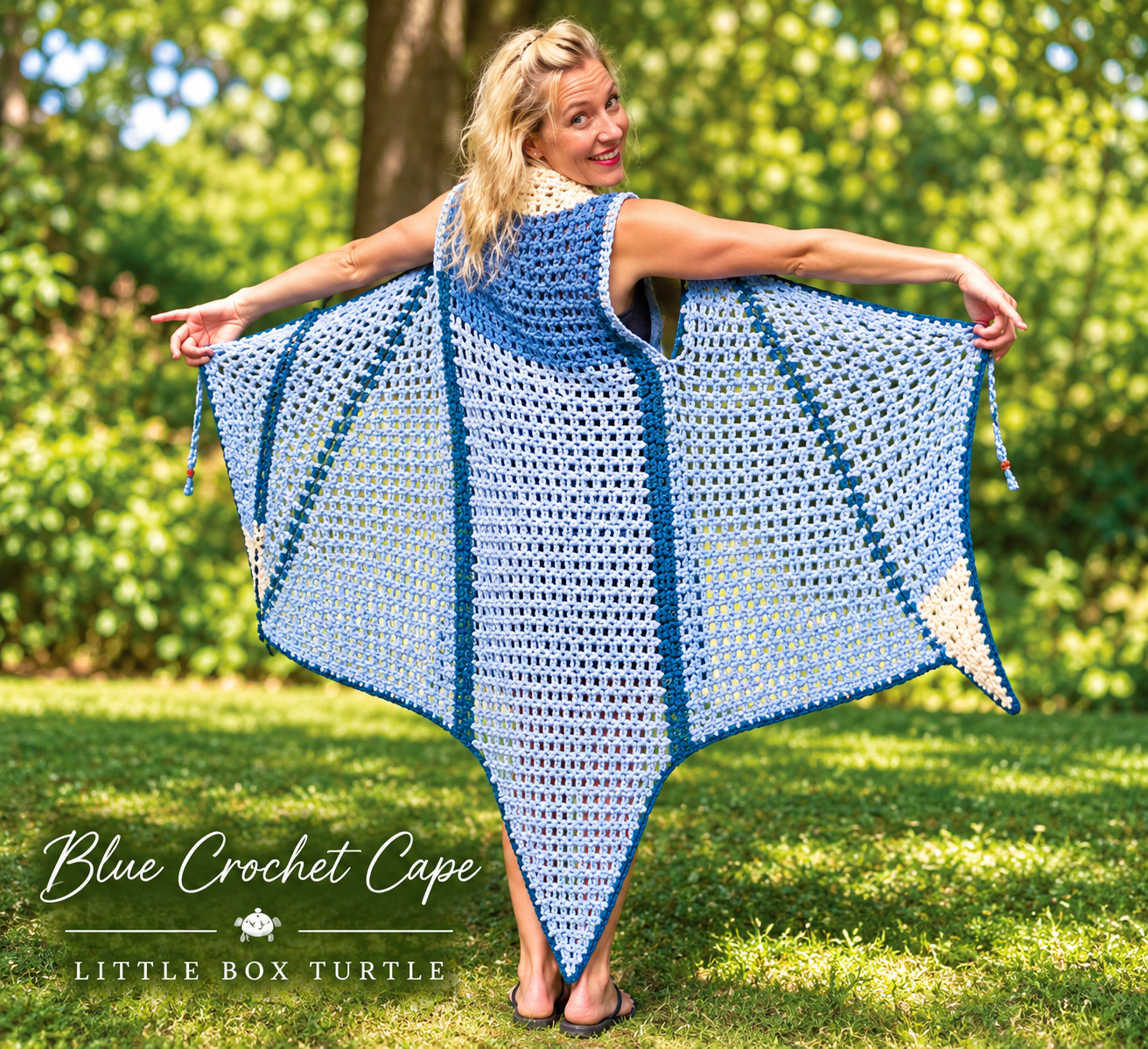 Blue Crochet Cape — blue and white openwork cape displayed outdoors